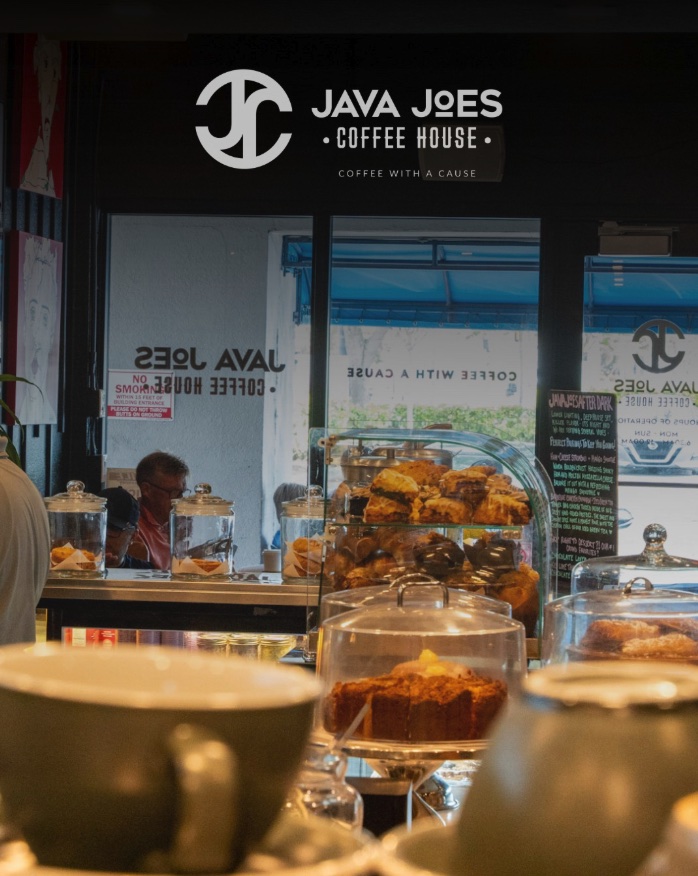 Inside Java Joes — pastry case, warm light, the counter